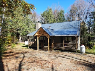 Before: a leaking standing seam metal roof on the home, Wilmington, Vermont, ahead of a Deep Charcoal Interlock Standing Seam aluminum roof