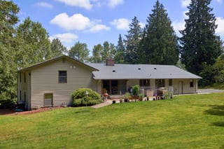 Musket Grey Interlock Cedar Shingle aluminum roof on a beige ranch-style home in a wooded suburban setting, Arlington, Washington