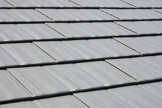 Musket Grey Interlock Cedar Shingle aluminum roof on a grey two-storey home with dormers and a metal roof in, Arlington, Washington