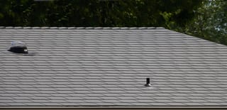 Musket Grey Interlock Cedar Shingle aluminum roof on a colonial home with dormers and grey roof in a forested, Arlington, Washington