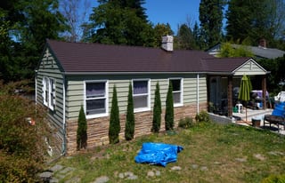 Colonial Brown Interlock Cedar Shingle aluminum roof on a Colonial Brown metal roof on a ranch-style home in a, Shoreline, Washington