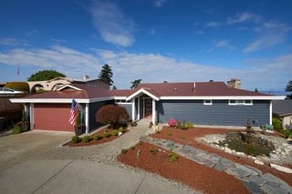 Aged Copper Interlock Cedar Shingle aluminum roof on a gray ranch-style home with a metal roof in a suburban, Burien, Washington