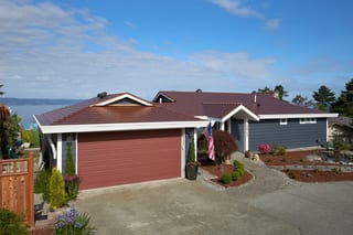 Aged Copper Interlock Cedar Shingle aluminum roof on a red ranch home with a metal roof overlooking a lake, Burien, Washington