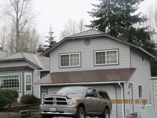 Colonial Brown Interlock Cedar Shingle aluminum roof on a Colonial brown metal roof on a two-storey grey home with, Renton, Washington