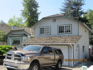 Before: a worn out wood shake roof on the home, Renton, Washington, ahead of a Colonial Brown Interlock Cedar Shingle aluminum roof