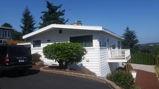 Before: the old roof on the home, Des Moines, Washington, ahead of a Black Interlock Standing Seam aluminum roof