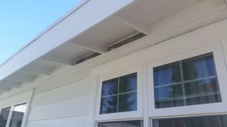 Before: the old roof on a white one-storey home with a black metal roof in a, Des Moines, Washington, ahead of a Black Interlock Standing Seam aluminum roof