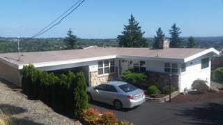 Before: the old roof on the home, Des Moines, Washington, ahead of a Black Interlock Standing Seam aluminum roof