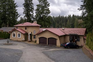 Tile Red Interlock Tile aluminum roof on a tan single-storey home with a red roof and a garage among, Woodinville, Washington