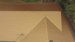 Aged Copper Interlock Cedar Shingle aluminum roof on a two-storey home with dormers in a suburban neighbourhood, Bellevue, Washington