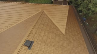 Aged Copper Interlock Cedar Shingle aluminum roof on a single-family modern home with metal roof in a forested, Bellevue, Washington