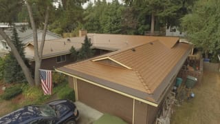 Aged Copper Interlock Cedar Shingle aluminum roof on a brown ranch style home with a brown metal roof in a, Bellevue, Washington