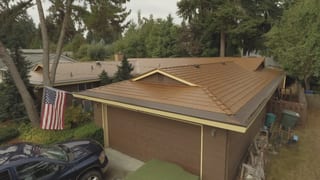 Aged Copper Interlock Cedar Shingle aluminum roof on a brown ranch home with a copper metal roof in a forested, Bellevue, Washington