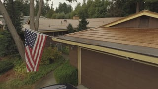Aged Copper Interlock Cedar Shingle aluminum roof on a modern home with a metal roof in a forested urban setting, Bellevue, Washington