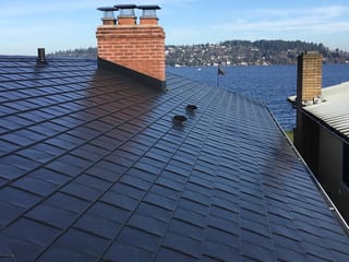 Black Interlock Slate aluminum roof on a black modern home with a metal roof overlooking the water, Seattle, Washington