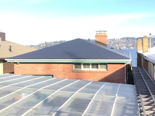 Black Interlock Slate aluminum roof on a black metal roof on a brick home with a chimney in a, Seattle, Washington