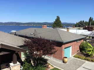 Before: a worn out asphalt shingle roof on the home, Seattle, Washington, ahead of a Black Interlock Slate aluminum roof