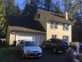 Before: a worn out asphalt shingle roof on the home, Poulsbo, Washington, ahead of a Black Interlock Slate aluminum roof