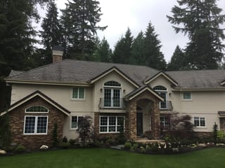 Before: a worn out concrete tile roof on the home, Bothell, Washington, ahead of a Black Interlock Slate aluminum roof