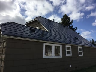 Deep Charcoal Interlock Slate aluminum roof on a dark brown single-family home with a metal roof in an, Tacoma, Washington
