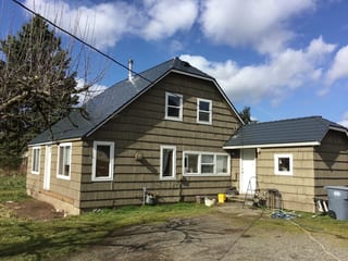 Deep Charcoal Interlock Slate aluminum roof on a brown single-storey home with a gable and dormer among, Tacoma, Washington