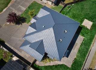 Deep Charcoal Interlock Tile aluminum roof on a Deep Charcoal metal roof on a single-storey home in a, Lynnwood, Washington