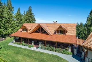 Copper Penny Interlock Shake aluminum roof on a brown chalet-style home with a copper penny metal roof in, Bellingham, Washington