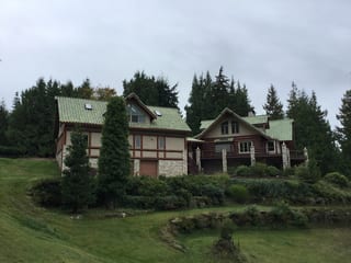 Before: a worn out clay tile roof on the home, Bellingham, Washington, ahead of a Copper Penny Interlock Shake aluminum roof