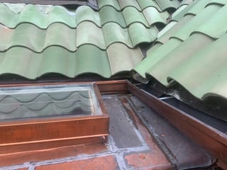 Before: a worn out clay tile roof on the home, Bellingham, Washington, ahead of a Copper Penny Interlock Shake aluminum roof
