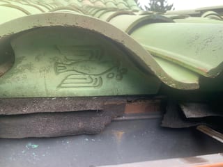 Before: a worn out clay tile roof on the home, Bellingham, Washington, ahead of a Copper Penny Interlock Shake aluminum roof