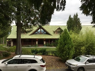 Before: a worn out clay tile roof on the home, Bellingham, Washington, ahead of a Copper Penny Interlock Shake aluminum roof