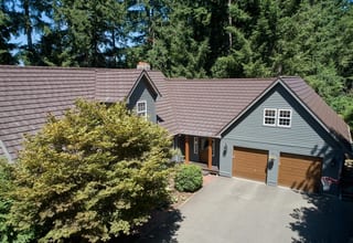 Colonial Brown Interlock Shake aluminum roof on a colonial style home with a brown metal roof in a forested, Gig Harbor, Washington