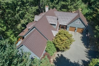 Colonial Brown Interlock Shake aluminum roof on a colonial home with a brown metal roof in a forested rural, Gig Harbor, Washington