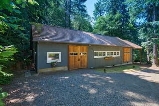 Colonial Brown Interlock Shake aluminum roof on a Colonial brown metal roof on a gray house in a forested, Gig Harbor, Washington