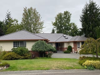 Tudor Brown Interlock Cedar Shingle aluminum roof on a Tudor brown metal roof on a ranch style home in a lush, Mill Creek, Washington