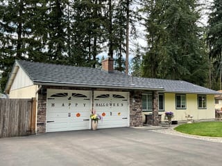 Deep Charcoal Interlock Shake aluminum roof on a yellow ranch home with a garage and chimney in a forested, Kent, Washington