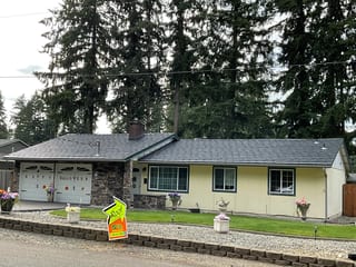 Deep Charcoal Interlock Shake aluminum roof on a single-storey ranch with stone and siding among tall trees, Kent, Washington