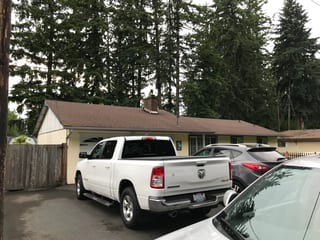 Before: a worn out asphalt shingle roof on the home, Kent, Washington, ahead of a Deep Charcoal Interlock Shake aluminum roof