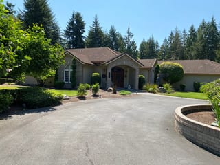 Before: a concrete tile roof with broken tiles on the home, Auburn, Washington, ahead of a Copper Penny Interlock Shake aluminum roof