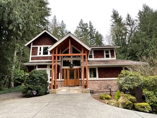 Before: a curling wood shake roof on the home, Fall City, Washington, ahead of a Hunter Green Interlock Standing Seam aluminum roof