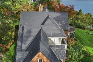 Black Interlock Slate aluminum roof on a black two-storey modern home with dormers by the, Seattle, Washington