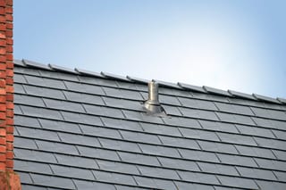 Black Interlock Slate aluminum roof on a black metal roof on a house with a brick chimney, Seattle, Washington