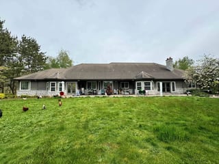 Before: a concrete tile roof with broken tiles on the home, Ridgefield, Washington, ahead of a Black Interlock Slate aluminum roof