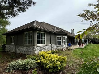 Before: a concrete tile roof with broken tiles on the home, Ridgefield, Washington, ahead of a Black Interlock Slate aluminum roof