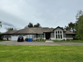 Before: a concrete tile roof with broken tiles on the home, Ridgefield, Washington, ahead of a Black Interlock Slate aluminum roof