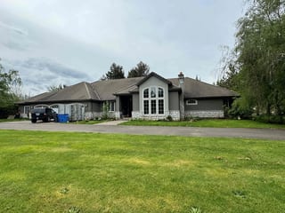 Before: a concrete tile roof with broken tiles on the home, Ridgefield, Washington, ahead of a Black Interlock Slate aluminum roof