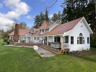 Copper Penny Interlock Shake aluminum roof on a white two-storey Craftsman home with copper penny metal, Bremerton, Washington