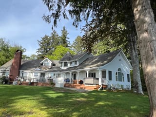 Before: a mossy asphalt shingle roof on the home, Bremerton, Washington, ahead of a Copper Penny Interlock Shake aluminum roof