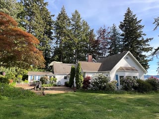 Before: a mossy asphalt shingle roof on the home, Bremerton, Washington, ahead of a Copper Penny Interlock Shake aluminum roof