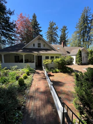 Before: a mossy asphalt shingle roof on the home, Bremerton, Washington, ahead of a Copper Penny Interlock Shake aluminum roof